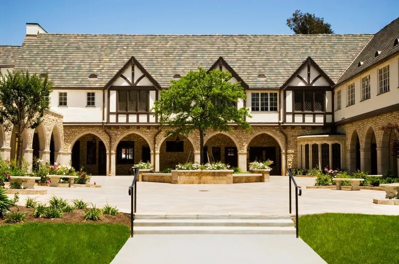 The SMCC courtyard surrounded by buildings with flat-stone colonnades and Tudor-style second levels.