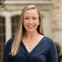 Rev. Jessica Vaughan Lower, Pastor & Head of Staff. A smiling blonde woman in a navy dress.