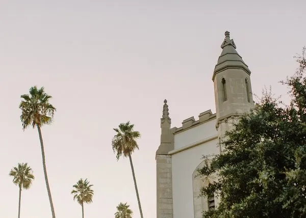 Palm trees and the top of the SMCC bell towers at dusk.